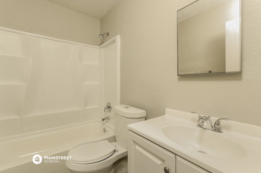 a white bathroom with a sink toilet and bath tub