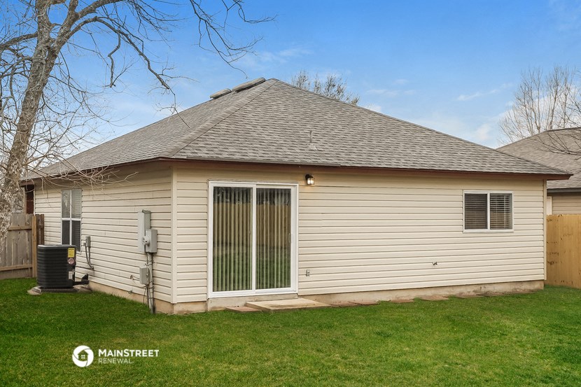 the backyard of a house with a yard and a garage