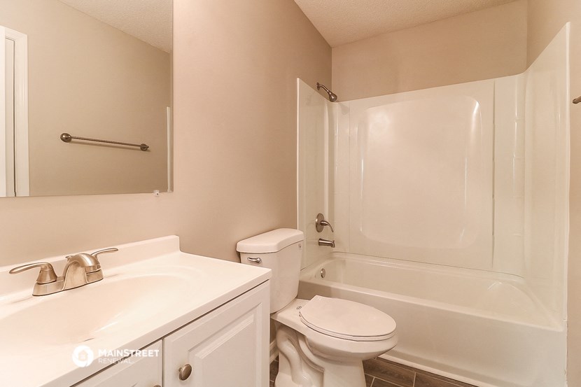 a bathroom with a sink toilet and a shower