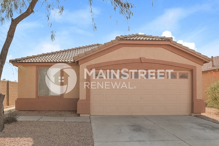 a house with a garage and a tree