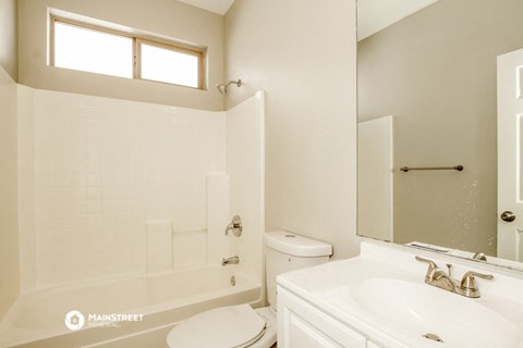 a bathroom with a sink toilet and a tub