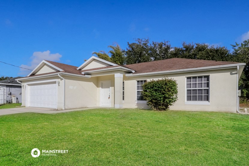a white house with a lawn in front of it