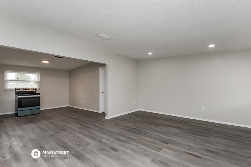 the spacious living room and kitchen of a 560 sq ft home