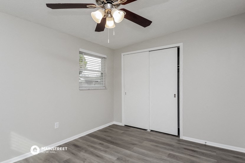 the living room of our studio apartment atrium with ceiling fan and closet
