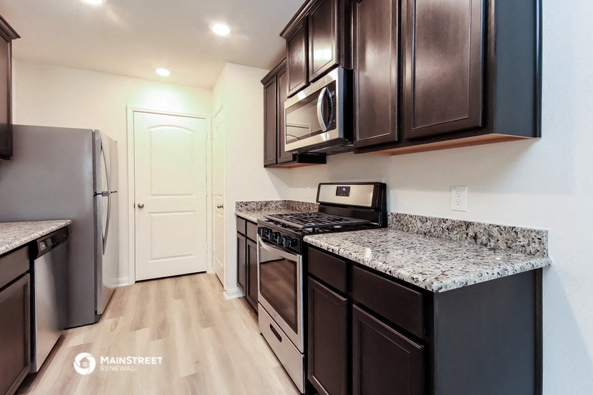 a kitchen with stainless steel appliances and granite counter tops