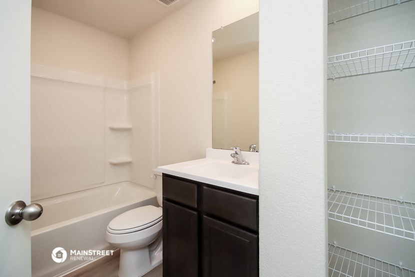 a bathroom with a sink toilet and a mirror