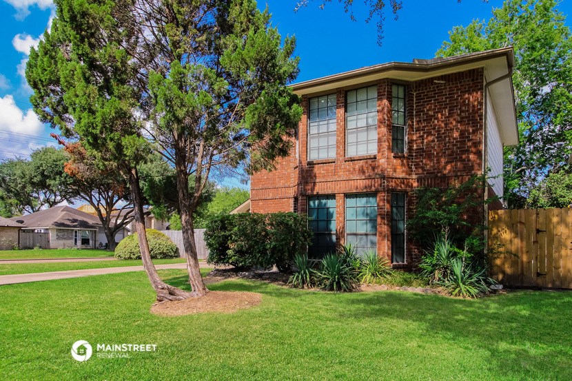 a brick house with a tree in front of it