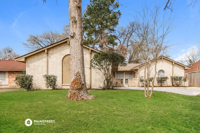 a house with a yard and a tree