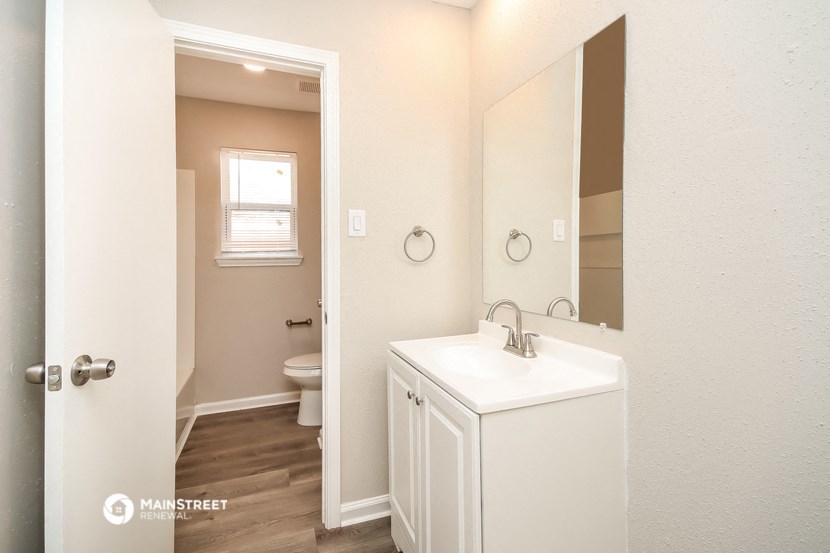 a bathroom with a sink and a mirror and a toilet