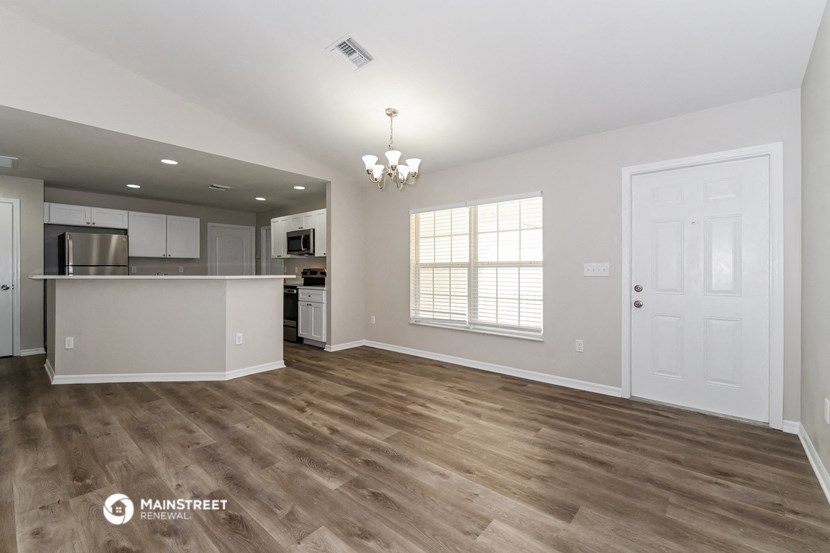 the living room and kitchen of a new home