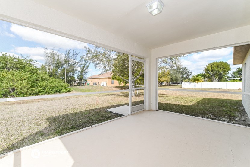 the living room of a house with a yard and a large window