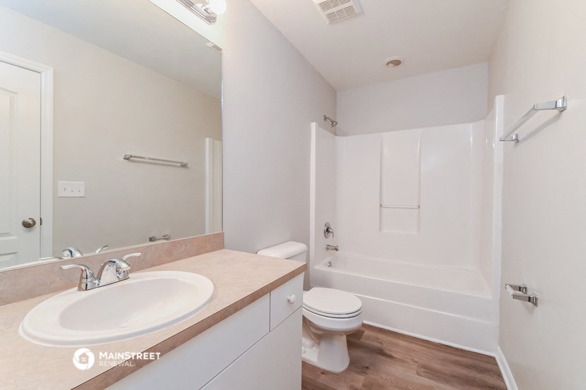a bathroom with a sink and a toilet and a shower