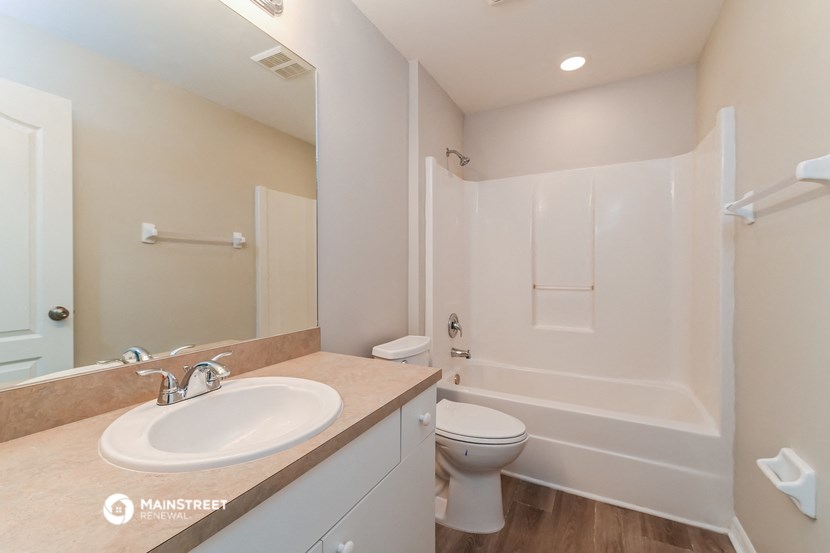 a bathroom with a sink and a toilet and a shower