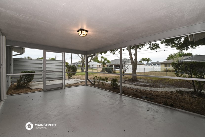 the screened in patio of a manufactured home with sliding glass doors to the yard