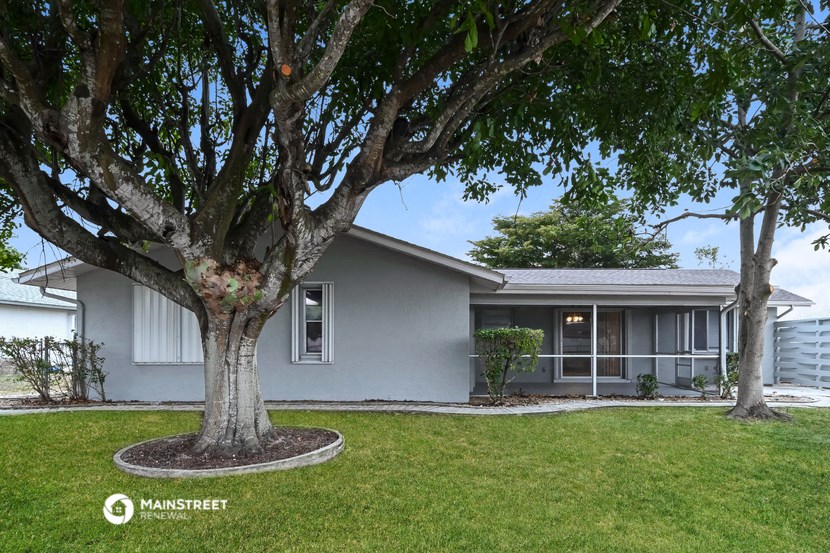 a house with a large tree in the front of it