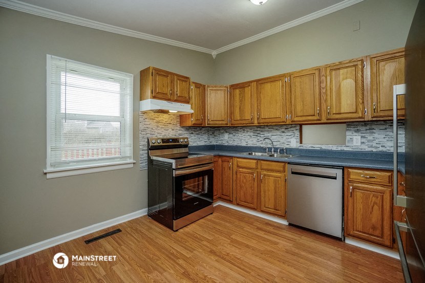 a kitchen with wooden cabinets and a sink and a window