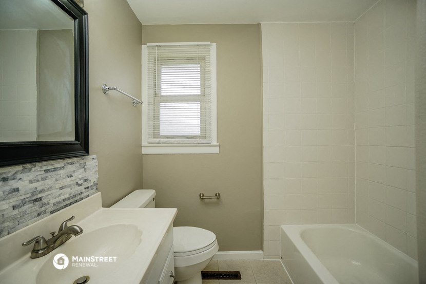 a bathroom with a sink toilet and a bath tub