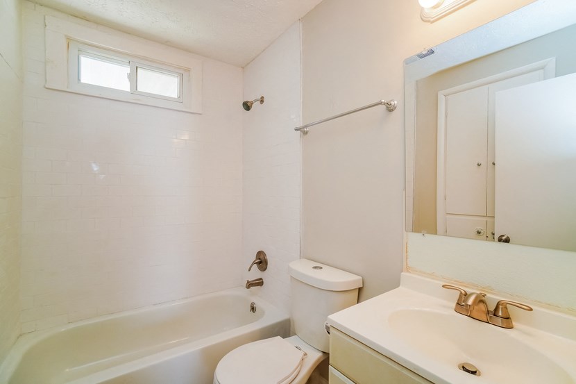 a bathroom with a sink toilet and a bath tub