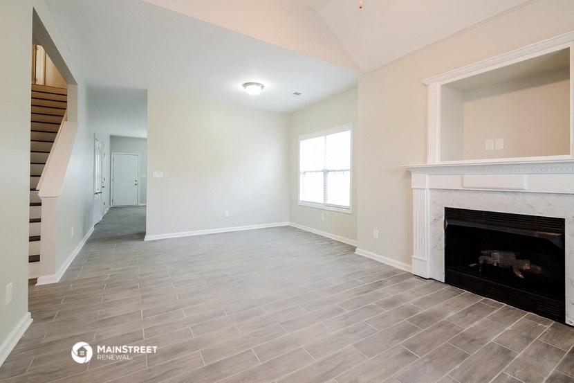 the living room has a fireplace and tile flooring