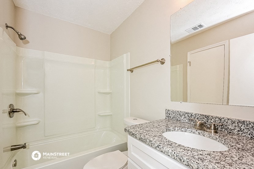 a bathroom with a sink and a toilet and a shower