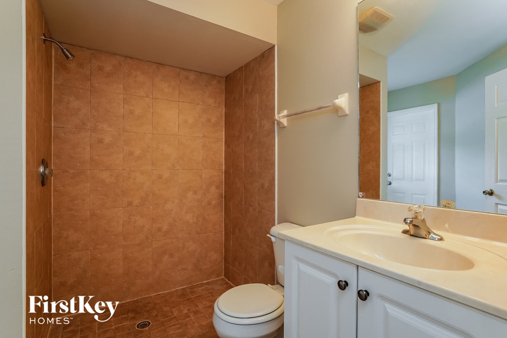 a bathroom with a sink toilet and a shower