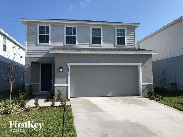 A two-story house with a garage is for sale.