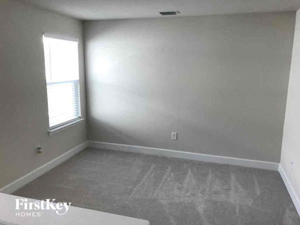 A room with a window and a Firstkey Homes logo.