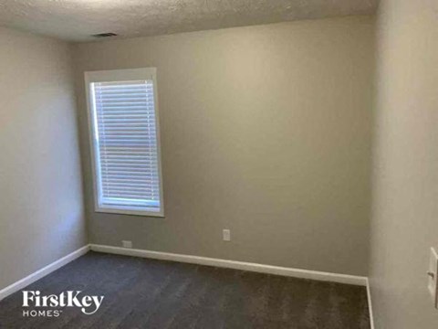A room with a window and a FirstKey Homes logo.