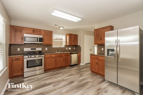 a kitchen with wooden cabinets and stainless steel appliances