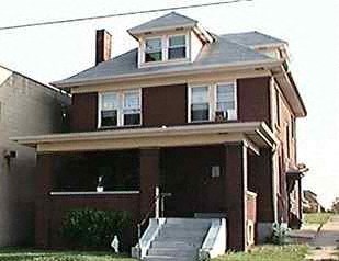 A two-story house with a garage on the first floor.