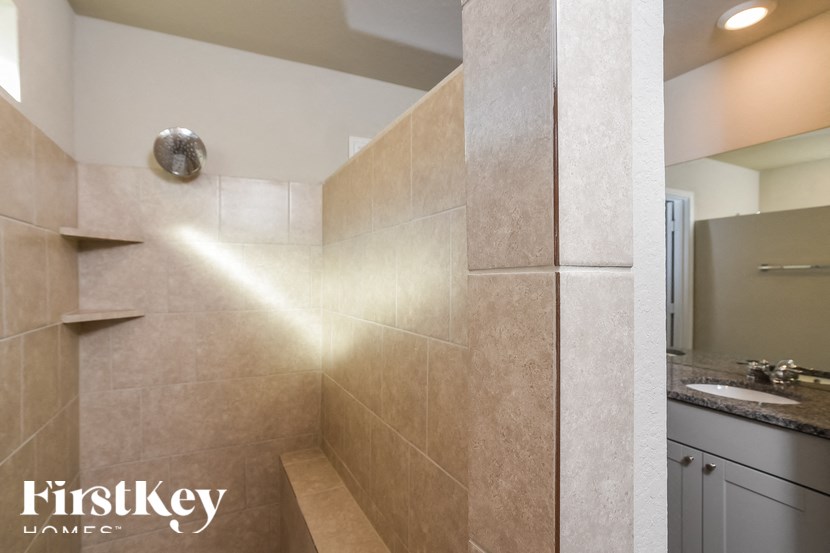 A bathroom with a shower and a sink.