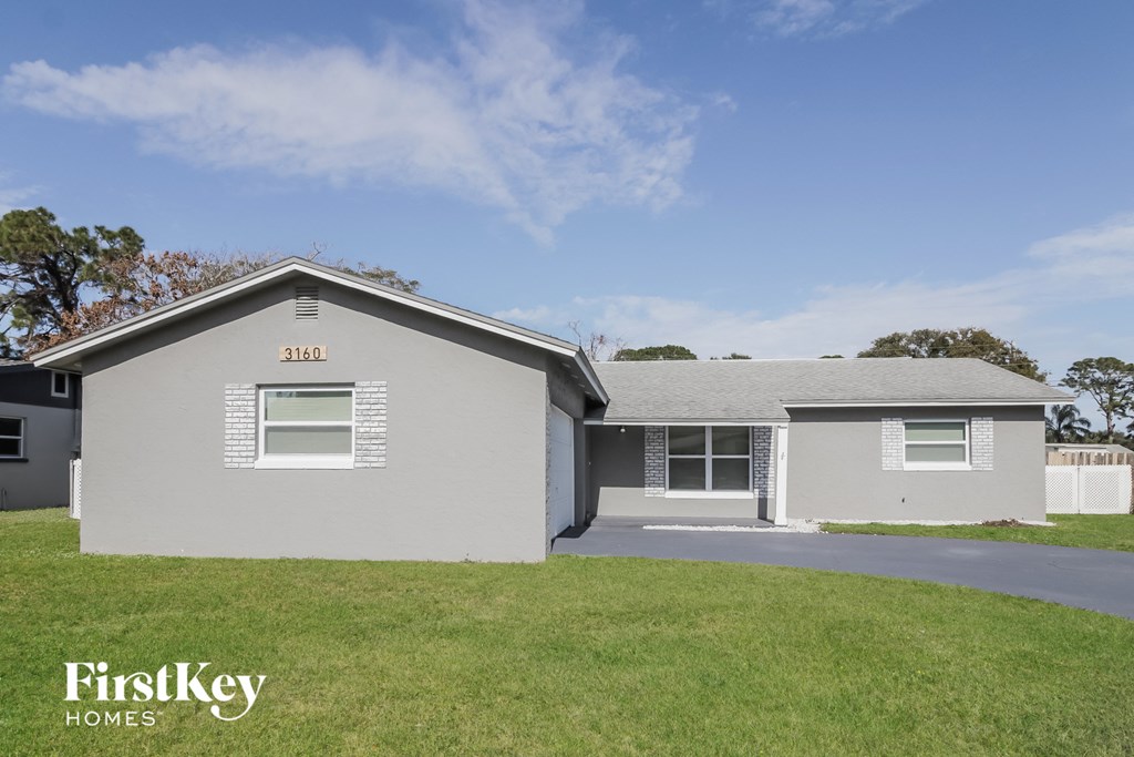 A grey house with the number 3160 on the front.