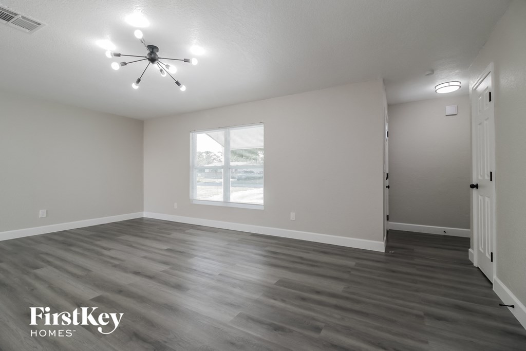 A room with a ceiling fan and a window.