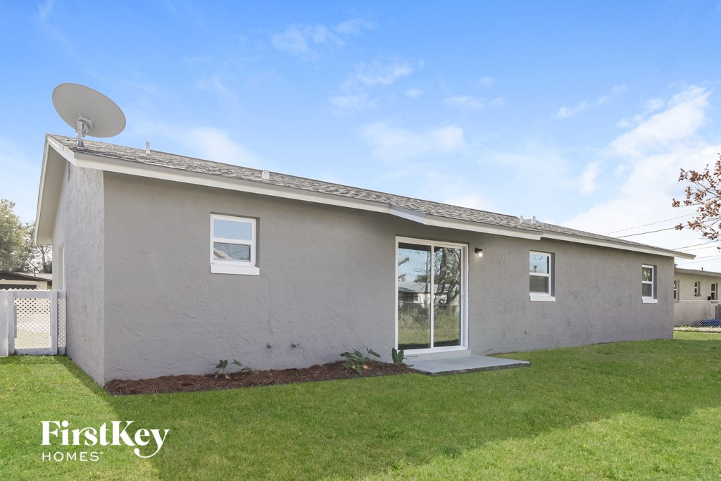 A house with a satellite dish on the roof.