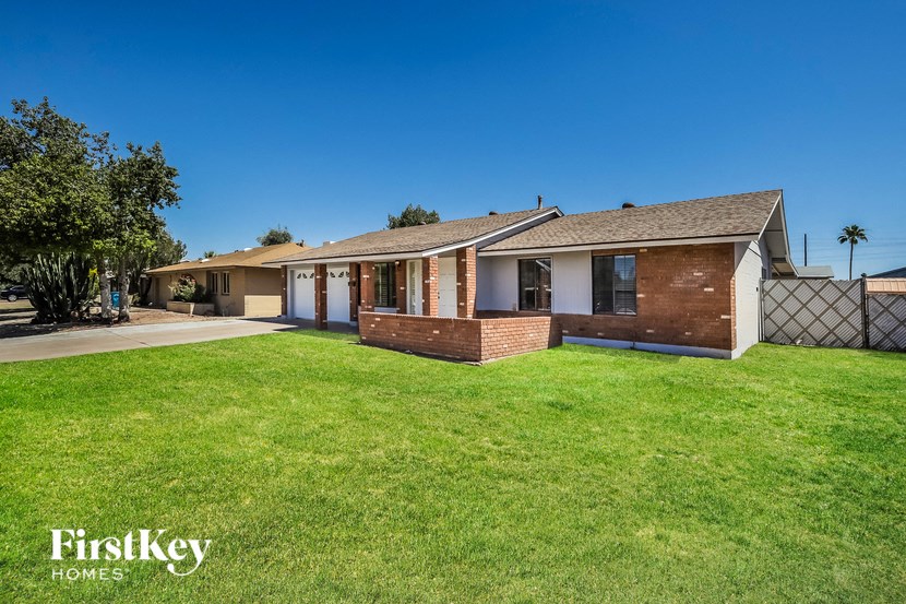 a house with a grass yard and a driveway