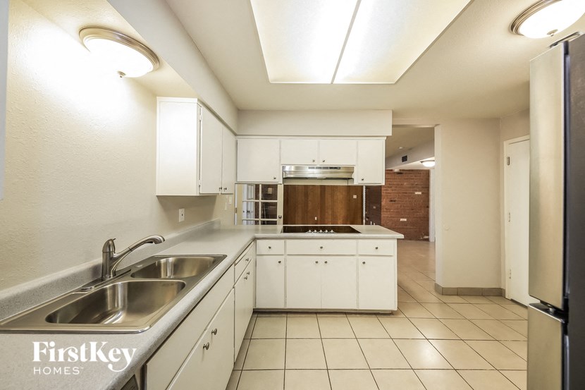 a kitchen with white cabinets and a sink