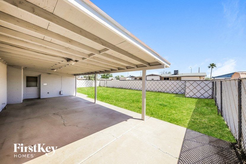 the backyard has a fenced in yard with a chain link fence