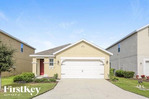 A house with a red door and a garage is shown.