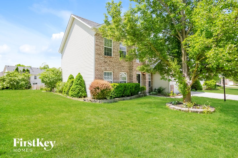 A house with a tree in front of it.