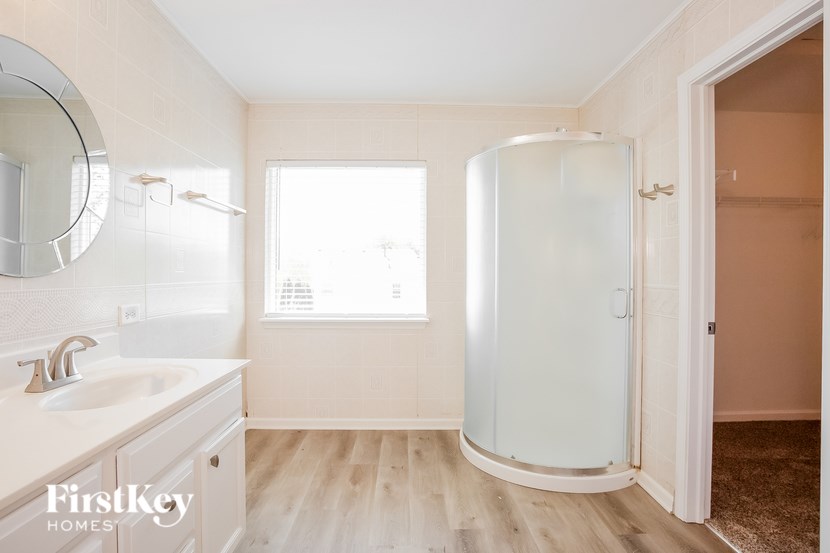 A bathroom with a white sink and a white cabinet.