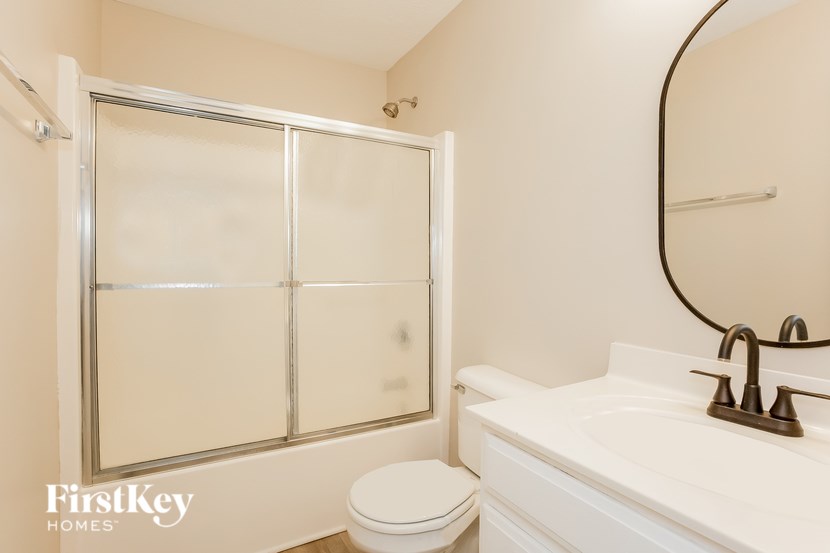 A white toilet sits next to a sink in a bathroom.