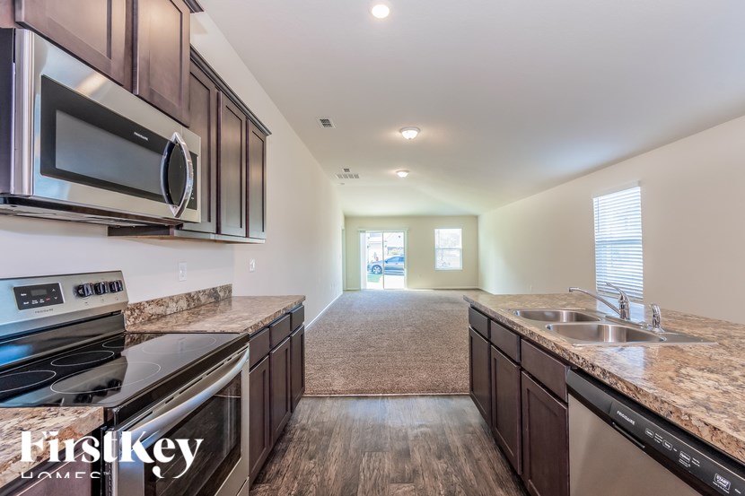 A kitchen with a stove top oven, microwave, and dishwasher.