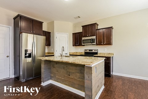A kitchen with wooden cabinets and a granite countertop.