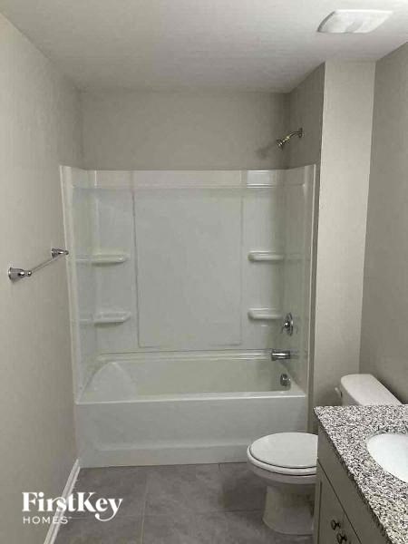 a bathroom with a shower and a toilet and a sink