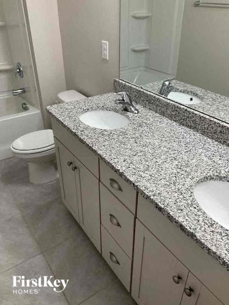 a bathroom with two sinks and a toilet