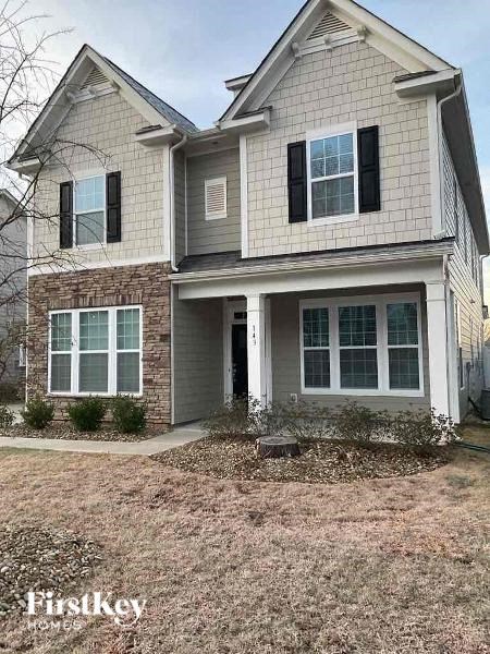 a white house with a yard in front of it