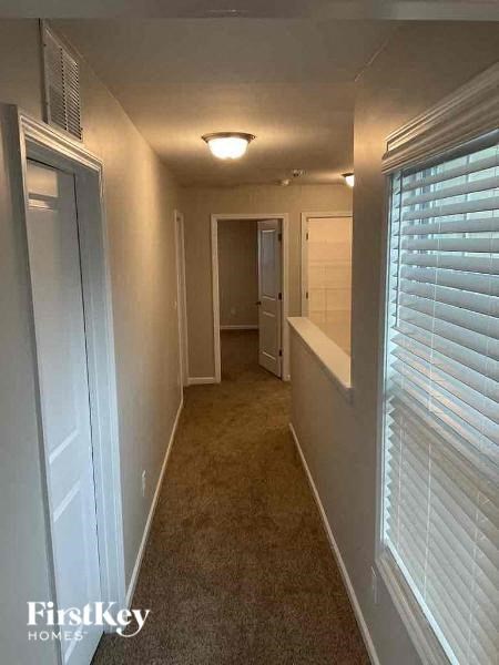 a hallway with a large window and a door