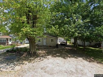a small house with a tree in front of it