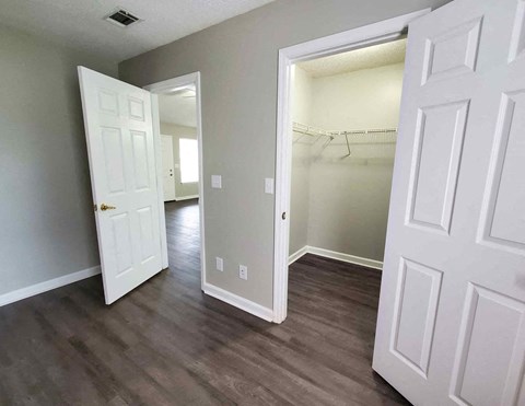 a living room with wood floors and a closet