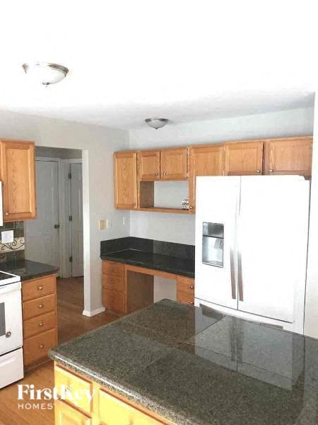a kitchen with a white refrigerator and a counter top